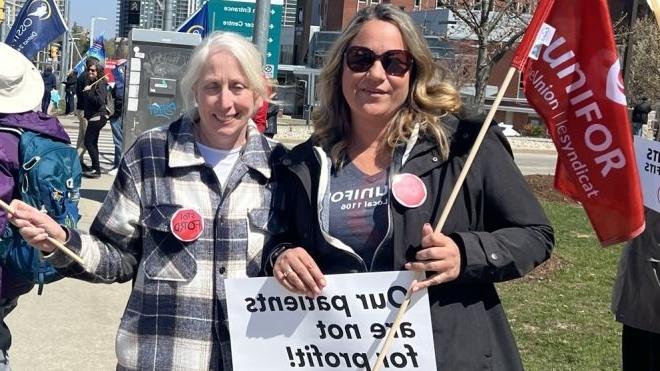 Two women at a rally at Grand River Hospital
